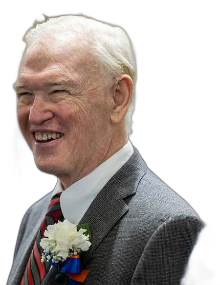 Howard J. Kopel smiling in a gray suit with a striped tie and white carnation boutonniere